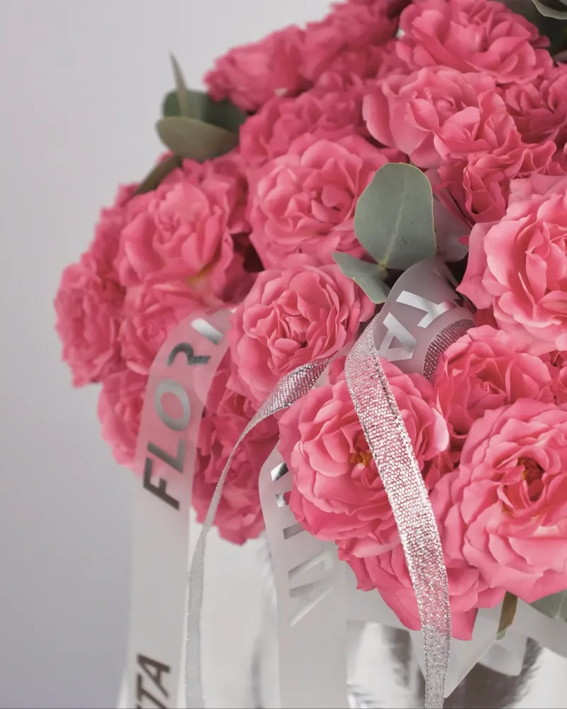 Vibrant pink rose bouquet in elegant metallic box
