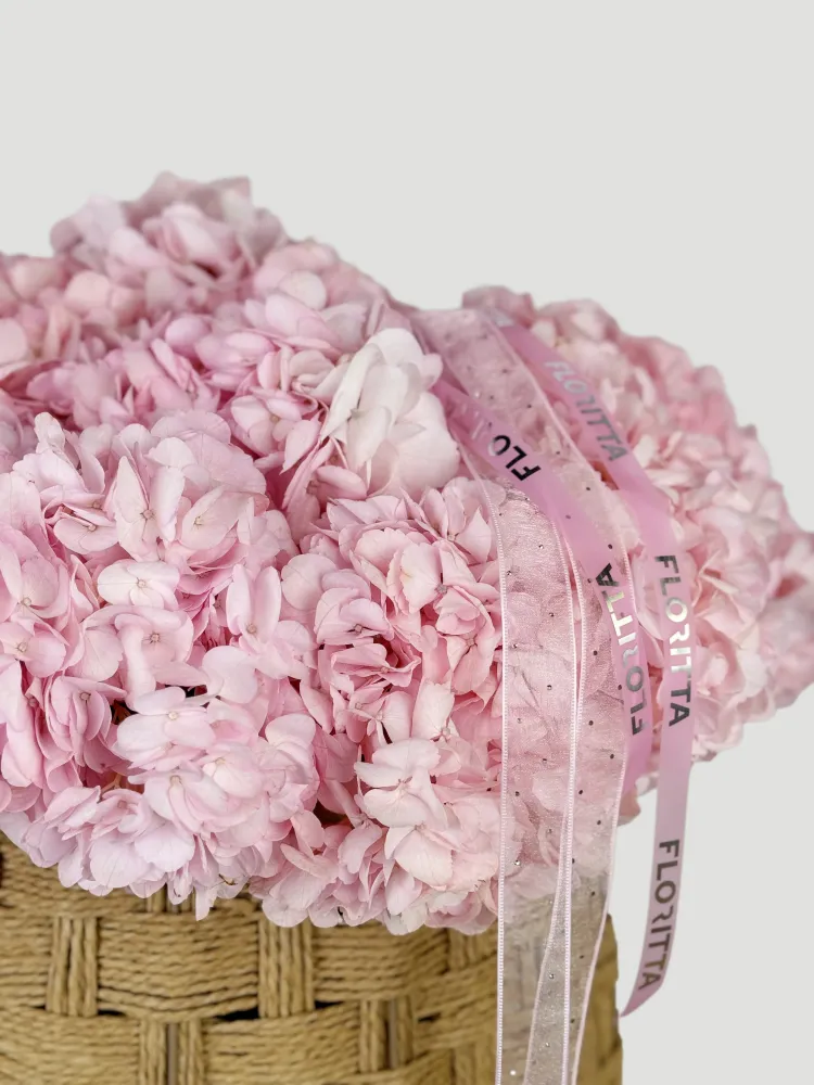 Lush blush pink hydrangea arrangement in woven basket with Floritta ribbon — London florist