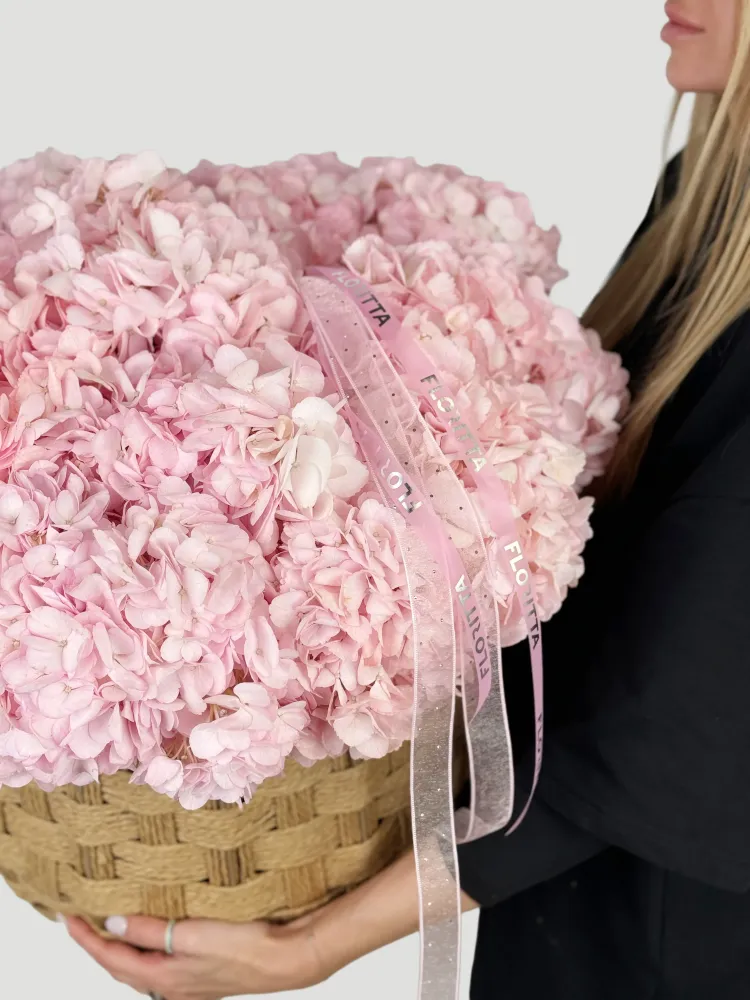 Abundant blush hydrangea bouquet in textured woven basket by Floritta