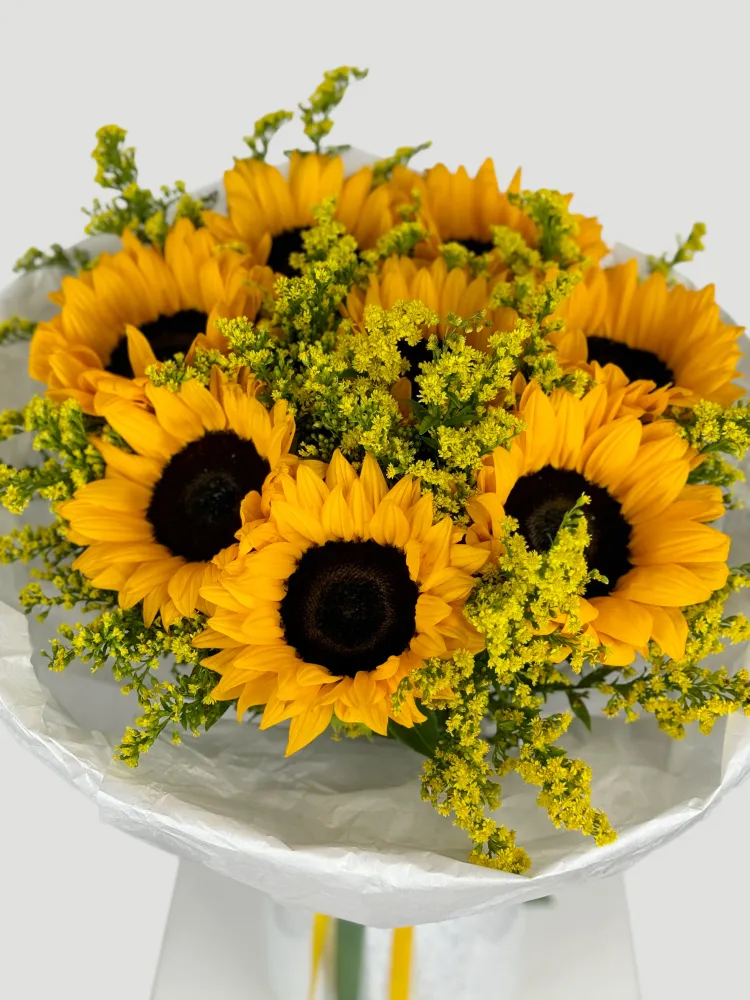 Bright yellow sunflowers and solidago in white paper wrap — Floritta