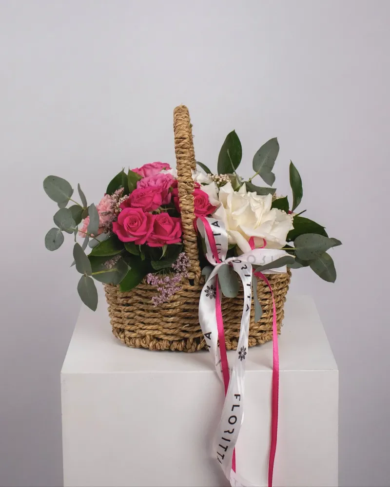 Luxe hot pink and cream roses with eucalyptus in woven basket — Floritta