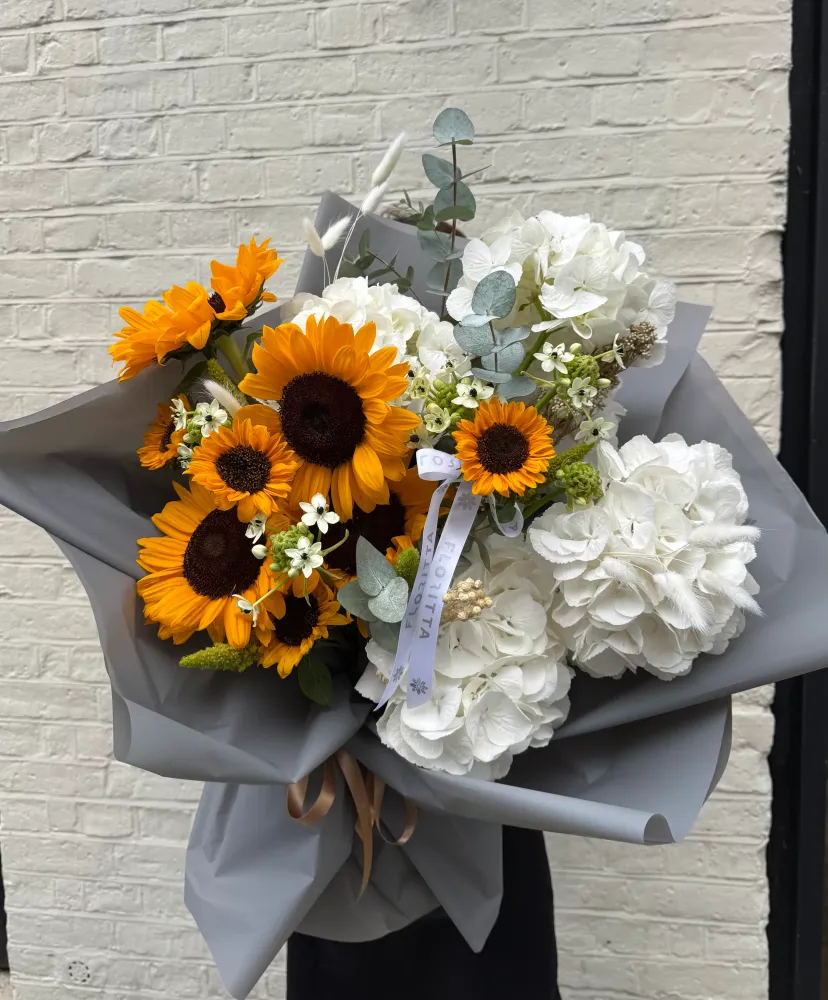 Sunflowers and white hydrangeas bouquet wrapped in grey paper — Floritta