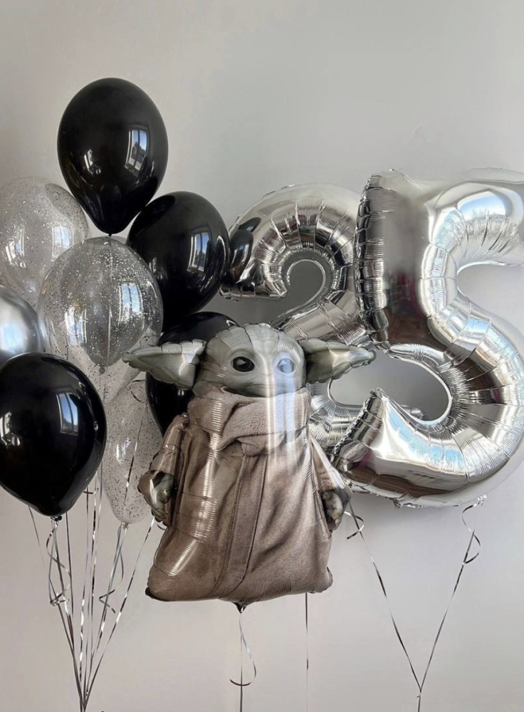 Silver and black foil balloons with character figure — celebratory arrangement by Floritta