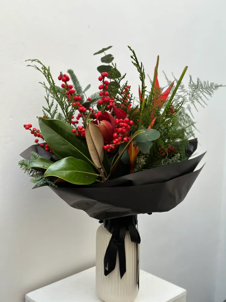 Red skimmia and anthurium bouquet with fern in black wrap — Floritta