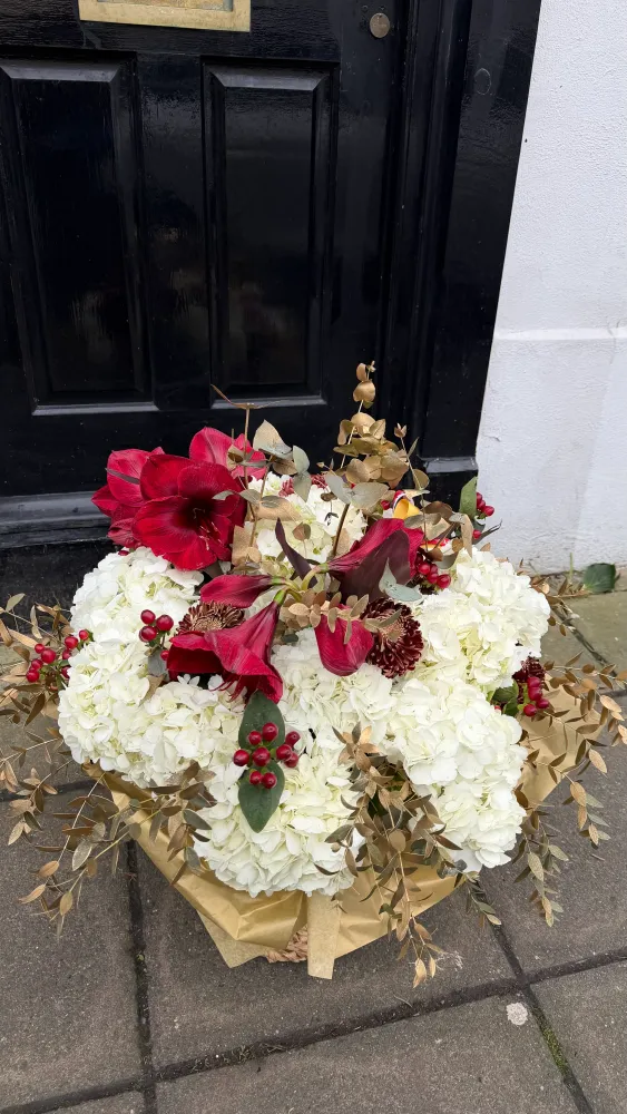 Luxe red and cream floral display with gold eucalyptus in seagrass pot — Floritta