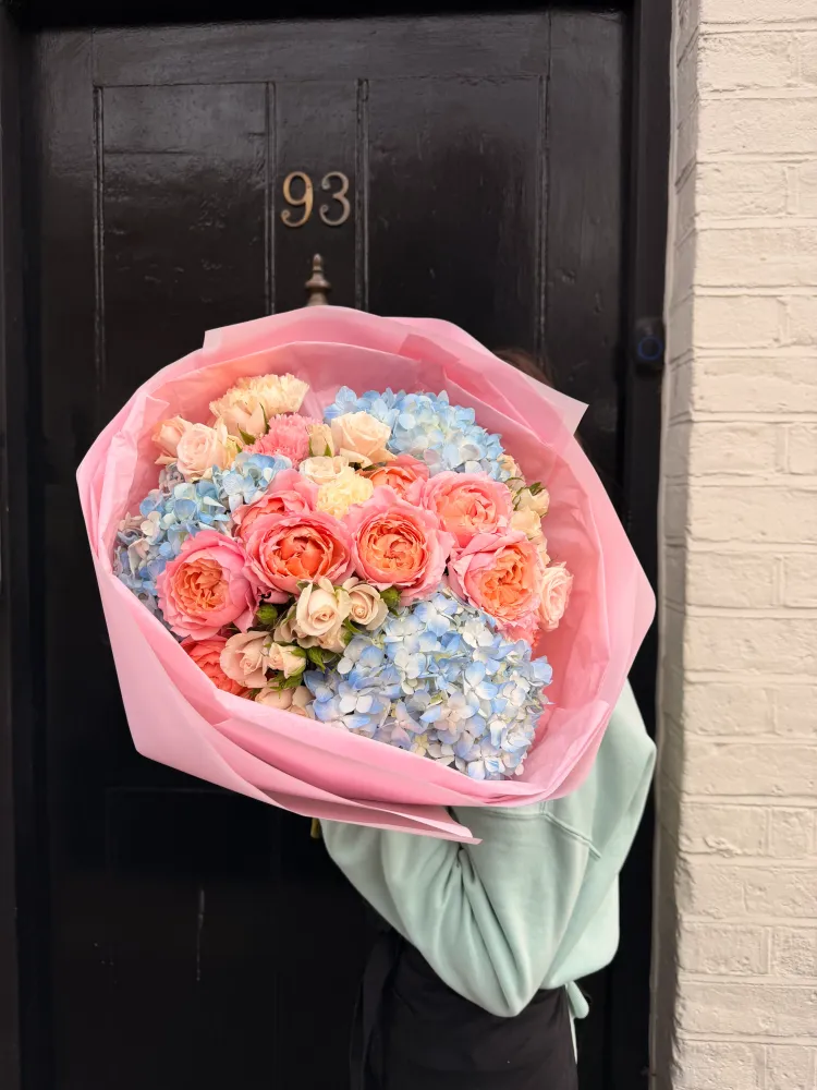 Luxe wrapped bouquet of coral peonies, blue hydrangeas and garden roses — Floritta