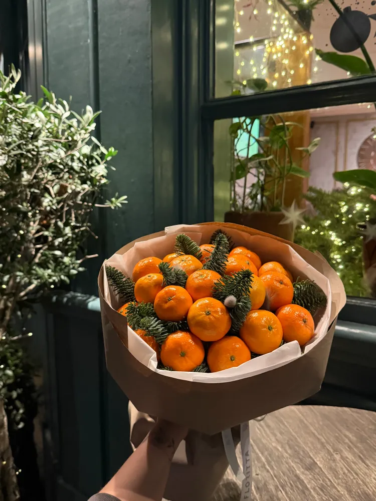 Vibrant orange citrus arrangement with skimmia and salal greenery, Floritta