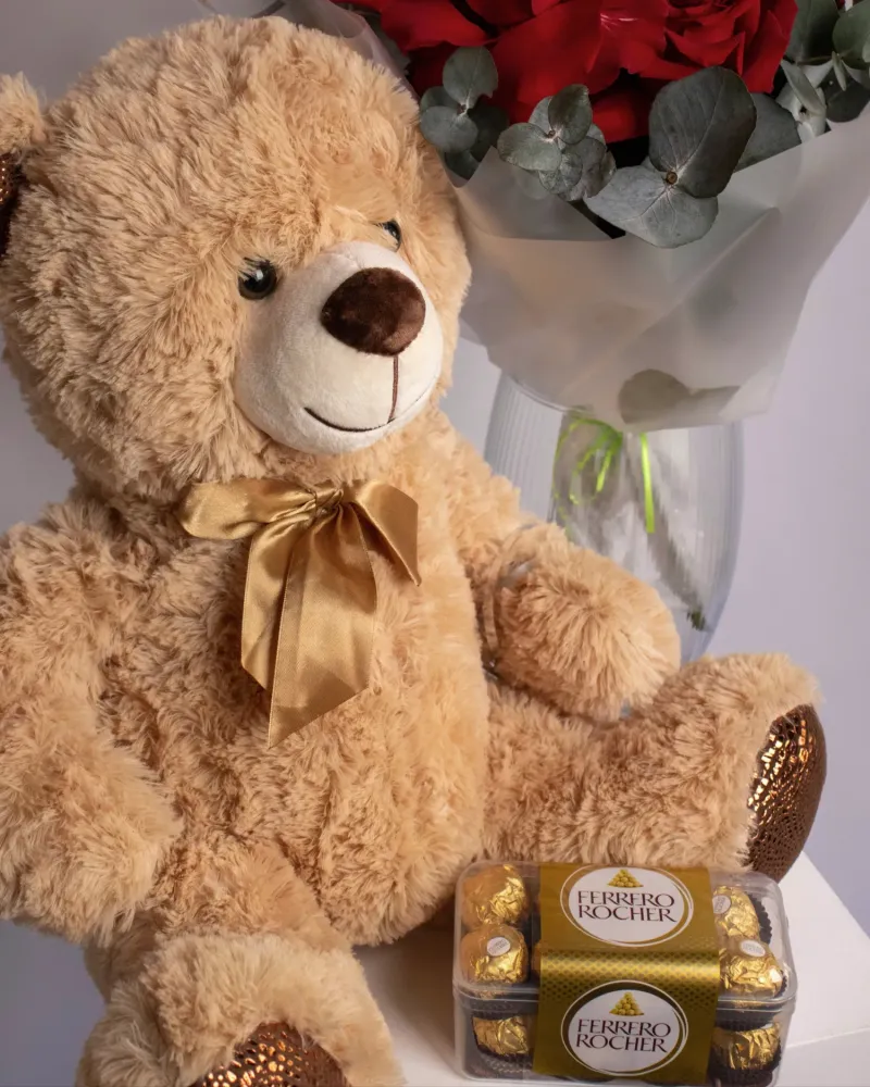 Lush red roses with eucalyptus in white vase, paired with cuddly bear — Floritta