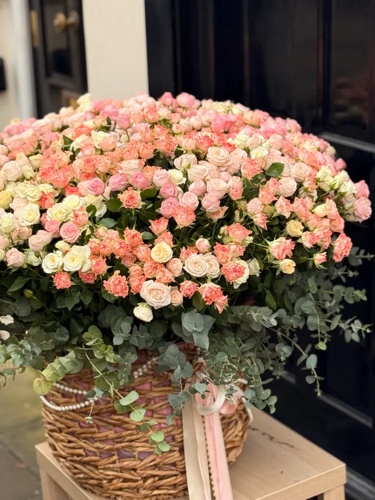Abundant rose arrangement in pink and cream shades with cascading eucalyptus foliage — Floritta