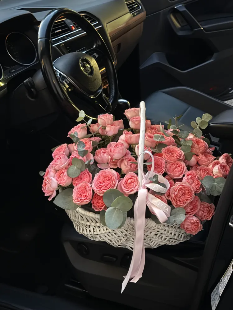 Luxurious coral-pink garden roses and eucalyptus in cream basket — Floritta