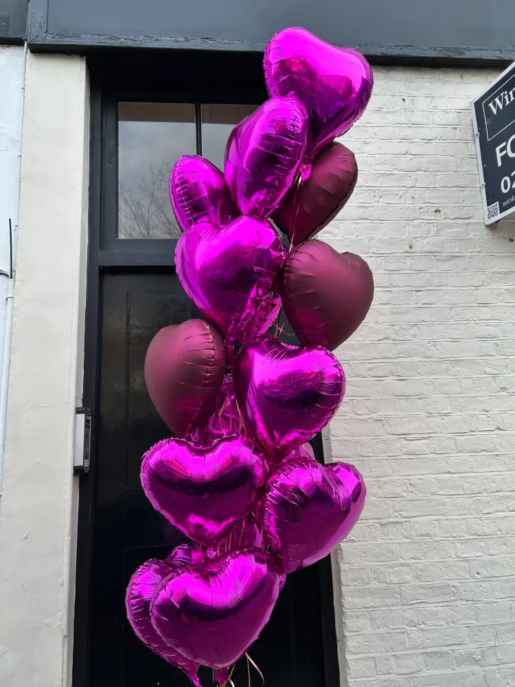 Vibrant magenta heart-shaped foil balloons cluster — Floritta celebration arrangement