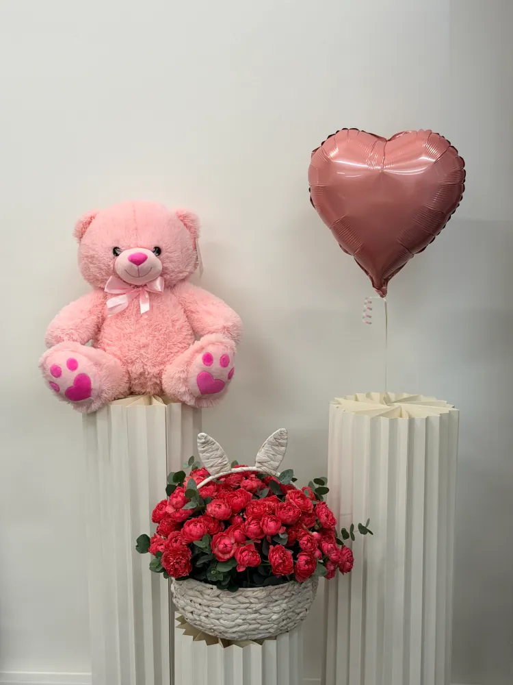 Lush red roses with eucalyptus in woven basket, styled with pink teddy and heart balloon — Floritta