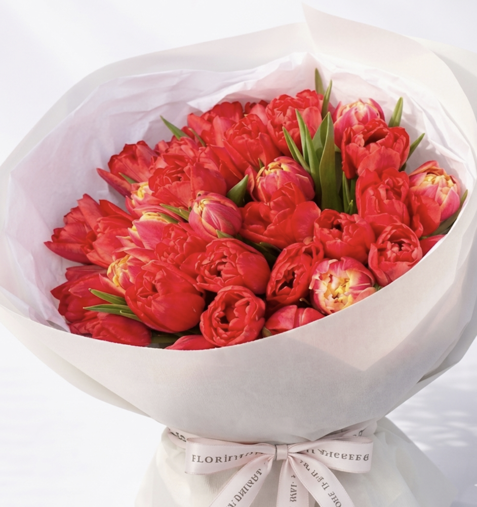 Luxurious bouquet of red coral peonies with green stems in white wrap — Floritta