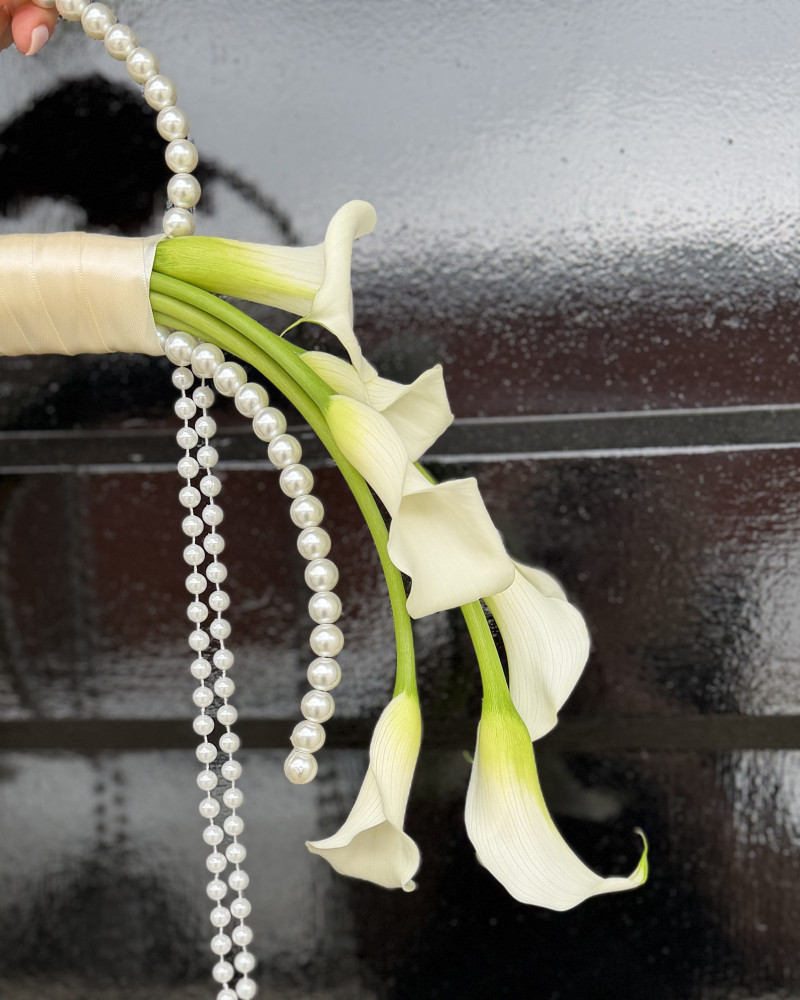 Close-up of cream calla lily cascade with pearl bead embellishment — Floritta