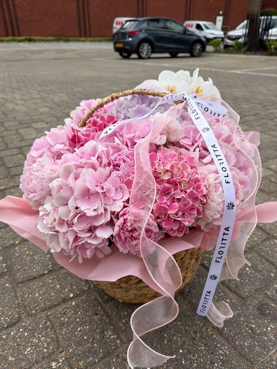 Pink hydrangea basket bouquet (hydrangeas, orchids, roses)
