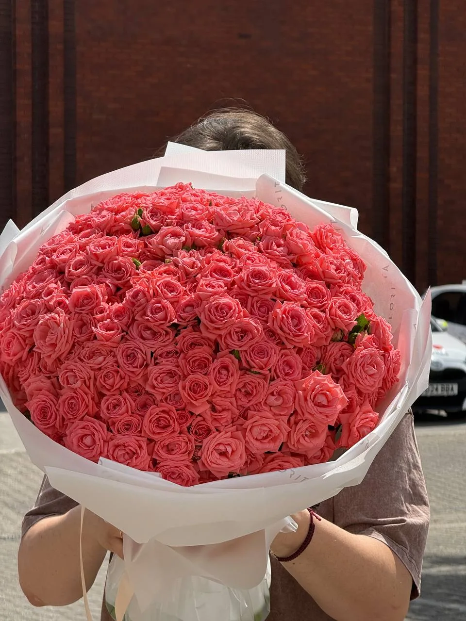 Coral spray roses bouquet in white wrap