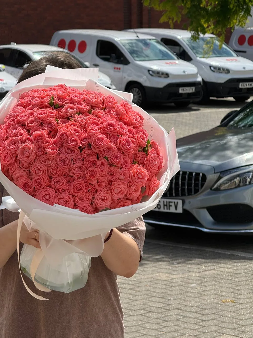 Coral spray roses bouquet in white wrap