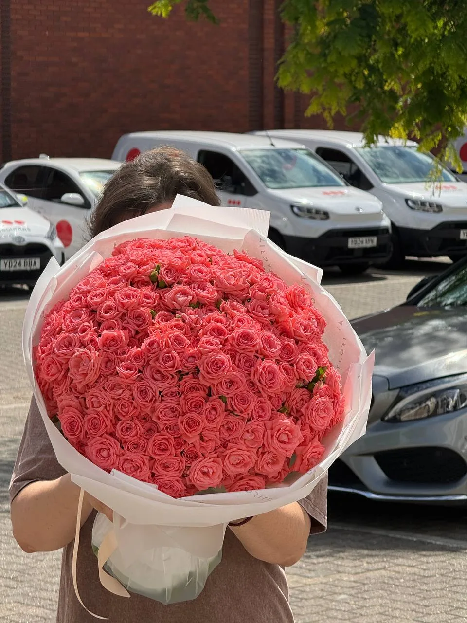 Coral spray roses bouquet in white wrap