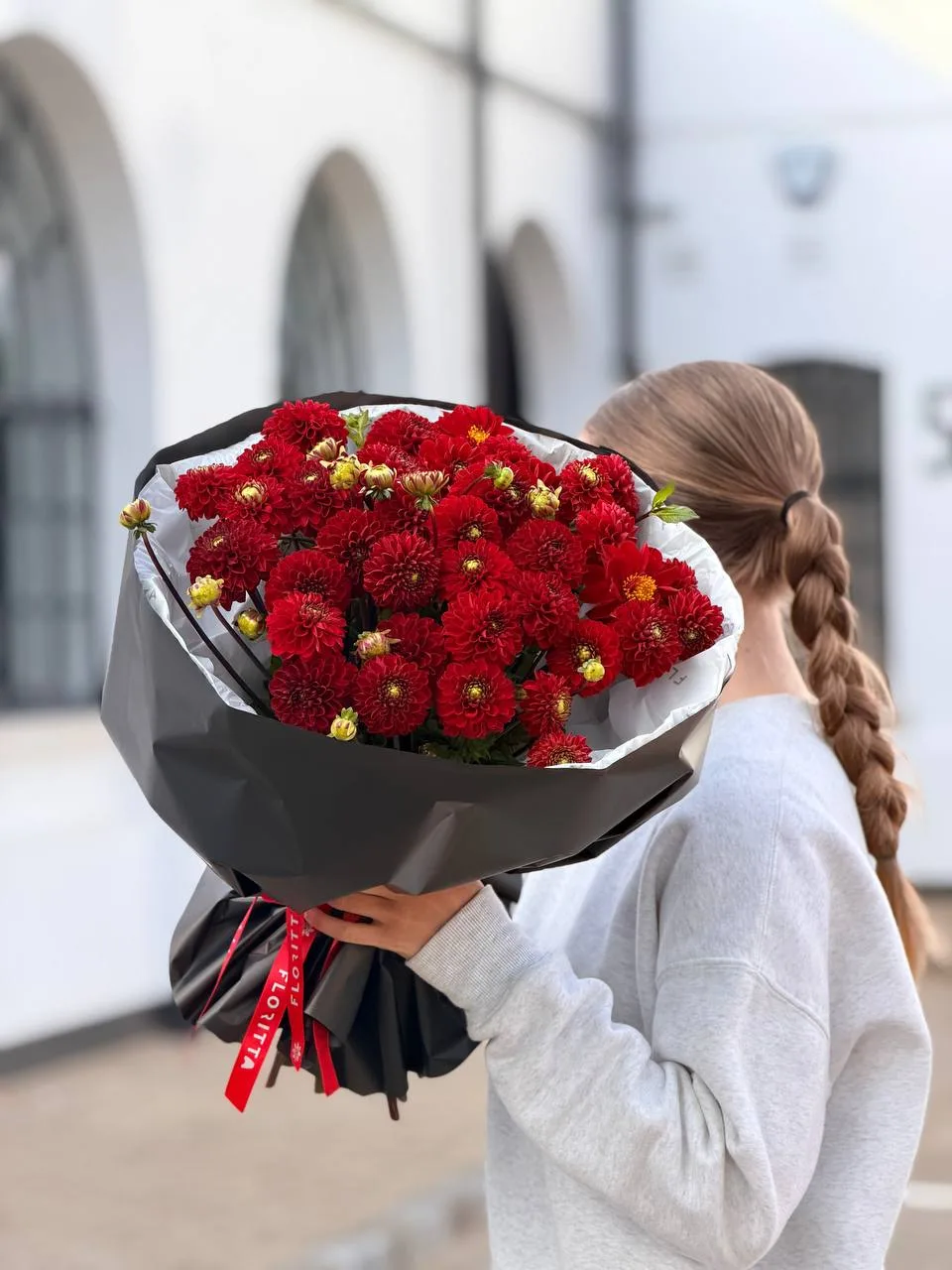 Red dahlia bouquet in black wrap