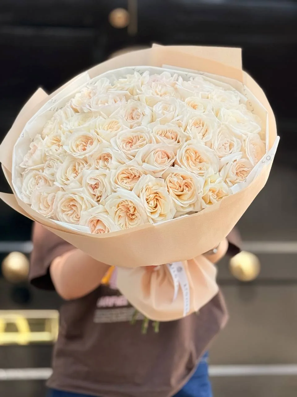 Cream peony roses bouquet in peach wrap