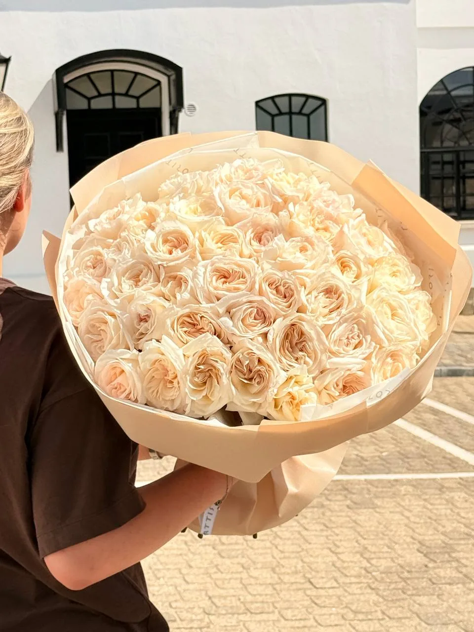 Cream peony roses bouquet in peach wrap