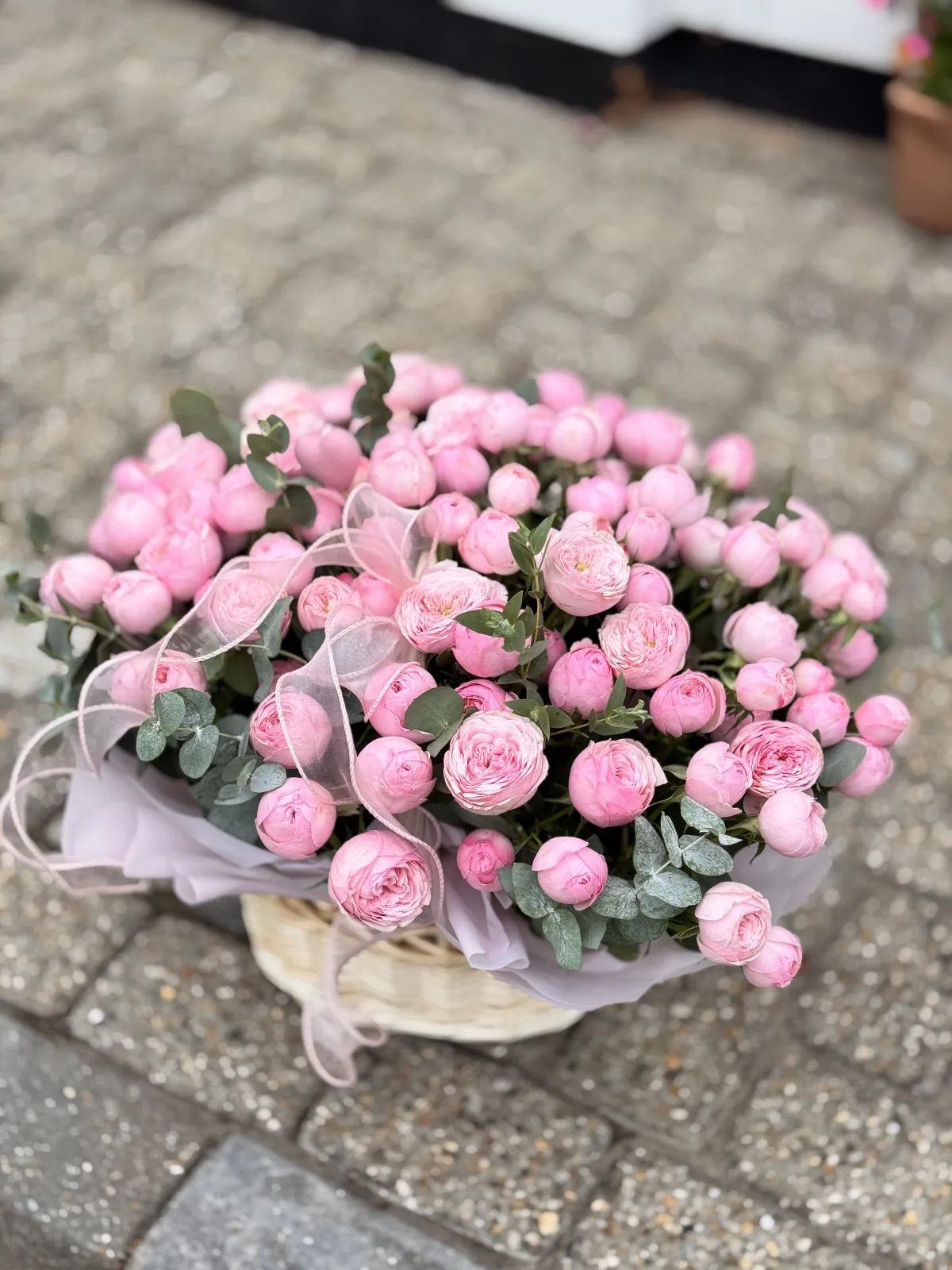 Pink peony spray rose basket with eucalyptus