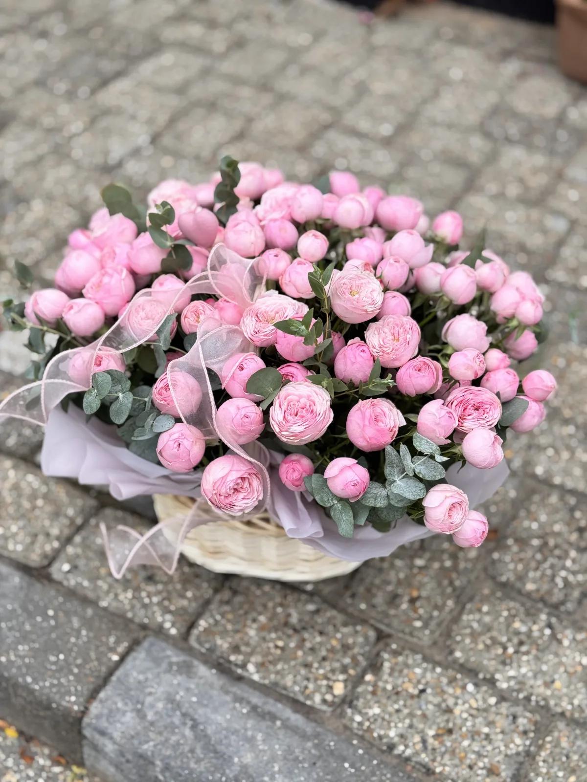 Pink peony spray rose basket with eucalyptus