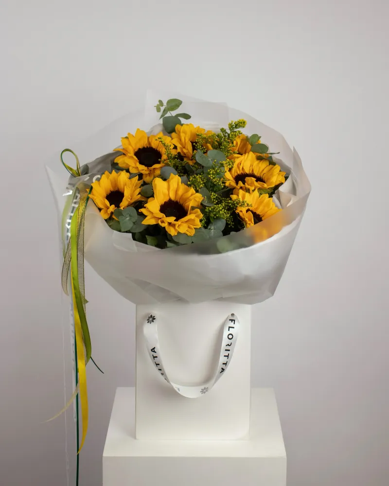 Golden sunflowers with eucalyptus in elegant white paper wrap — Floritta
