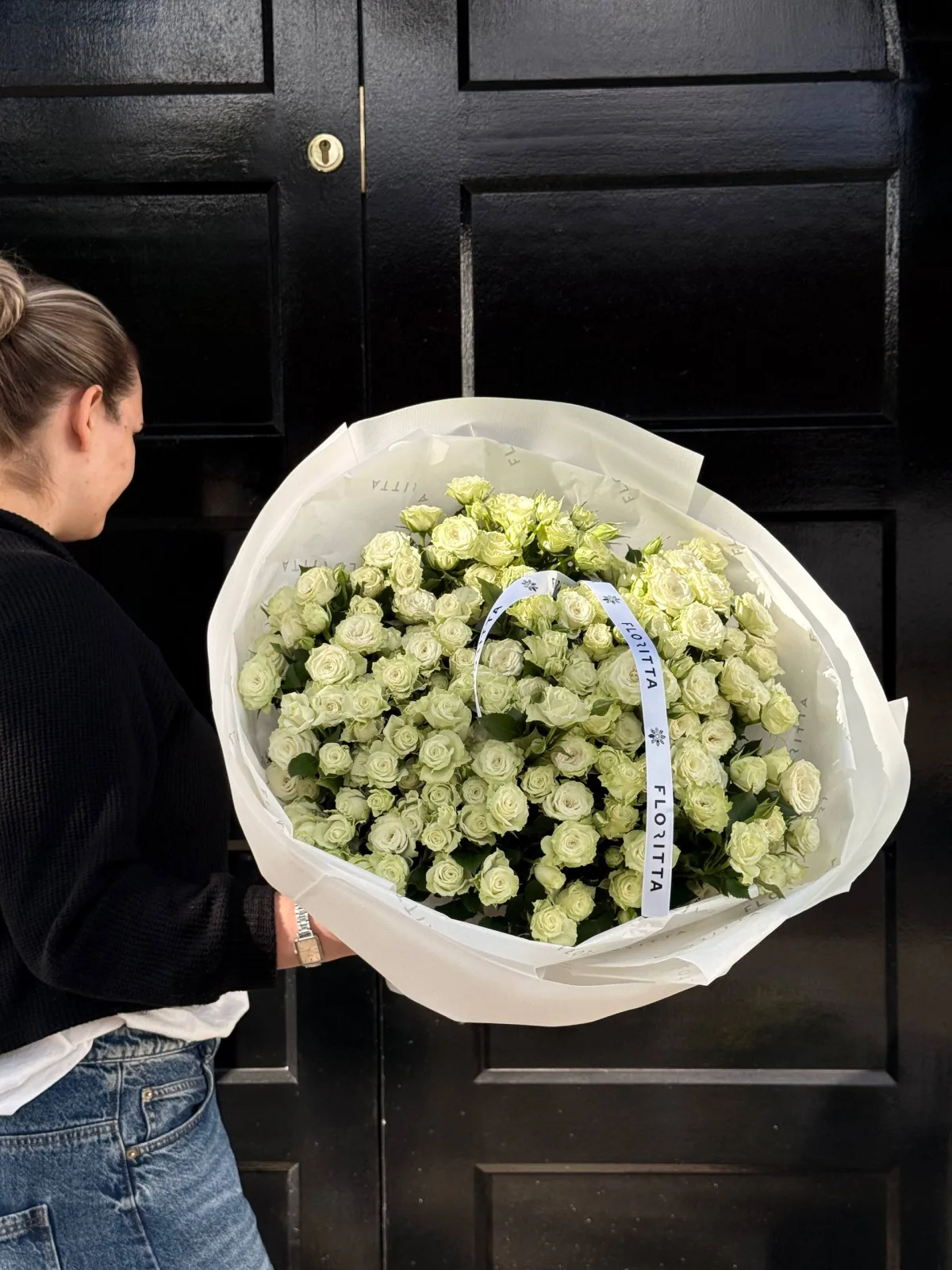 White spray roses bouquet in ivory wrap