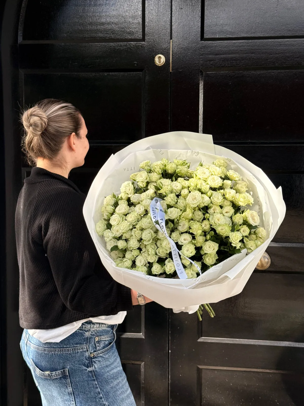 White spray roses bouquet in ivory wrap