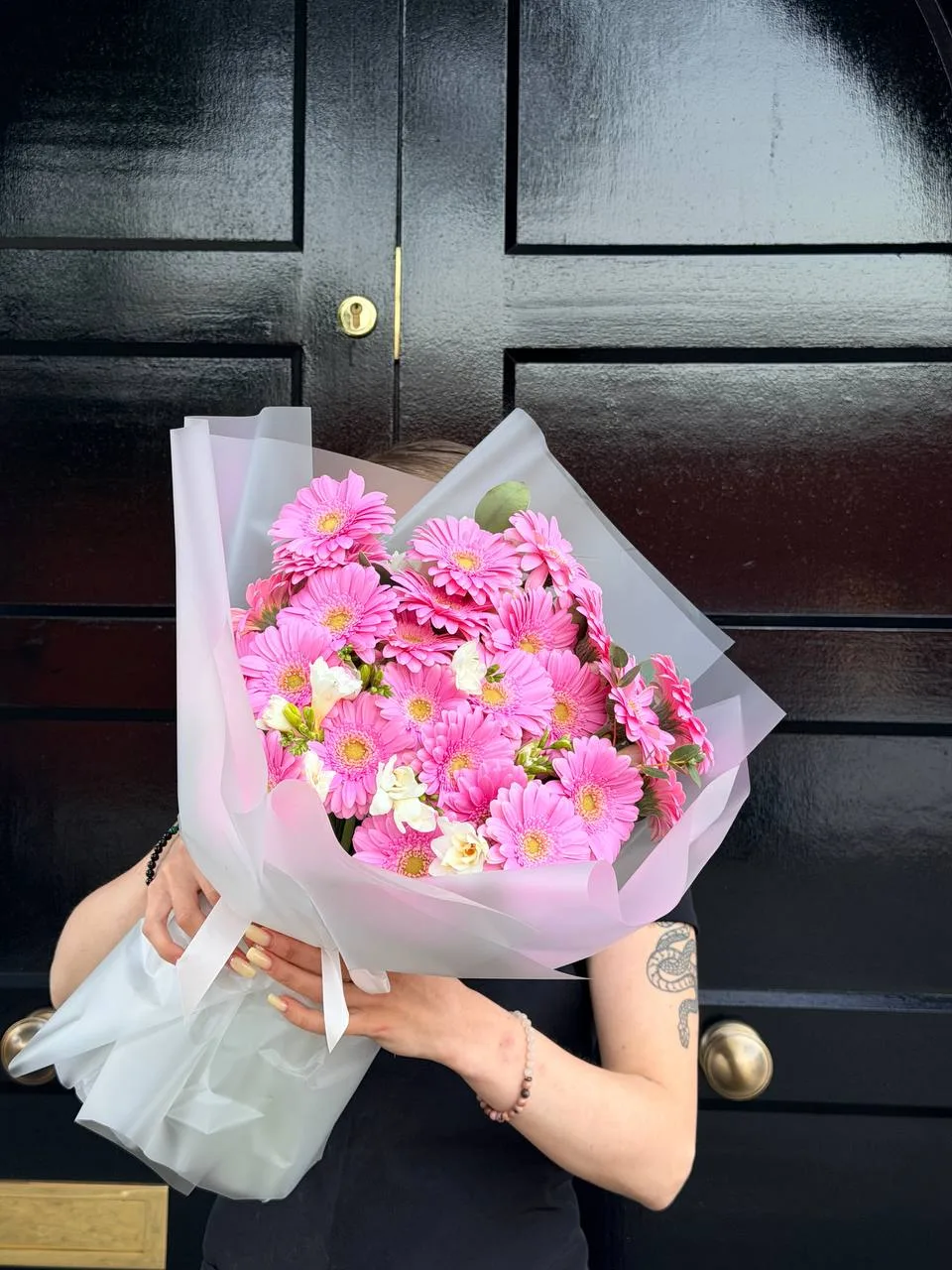 Pink gerbera bouquet with white freesia in ivory wrap