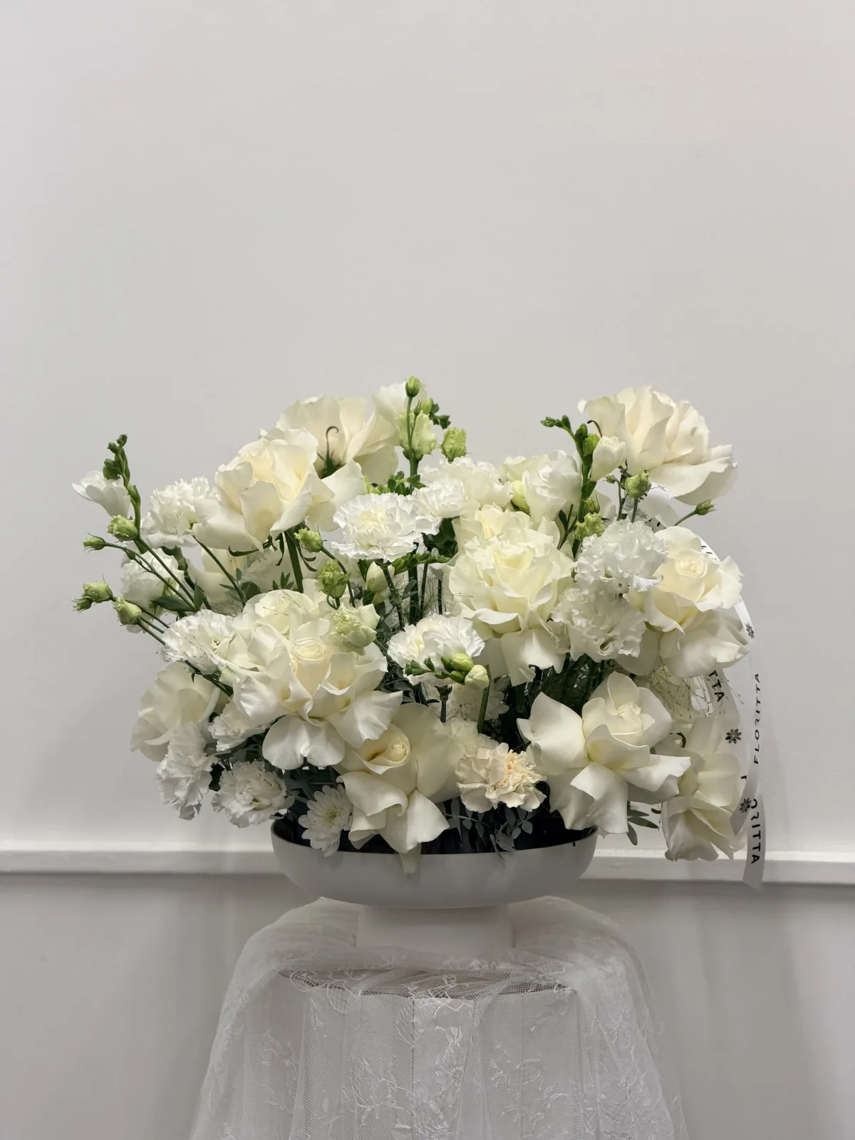Pure white bowl arrangement (roses, carnations, freesia)