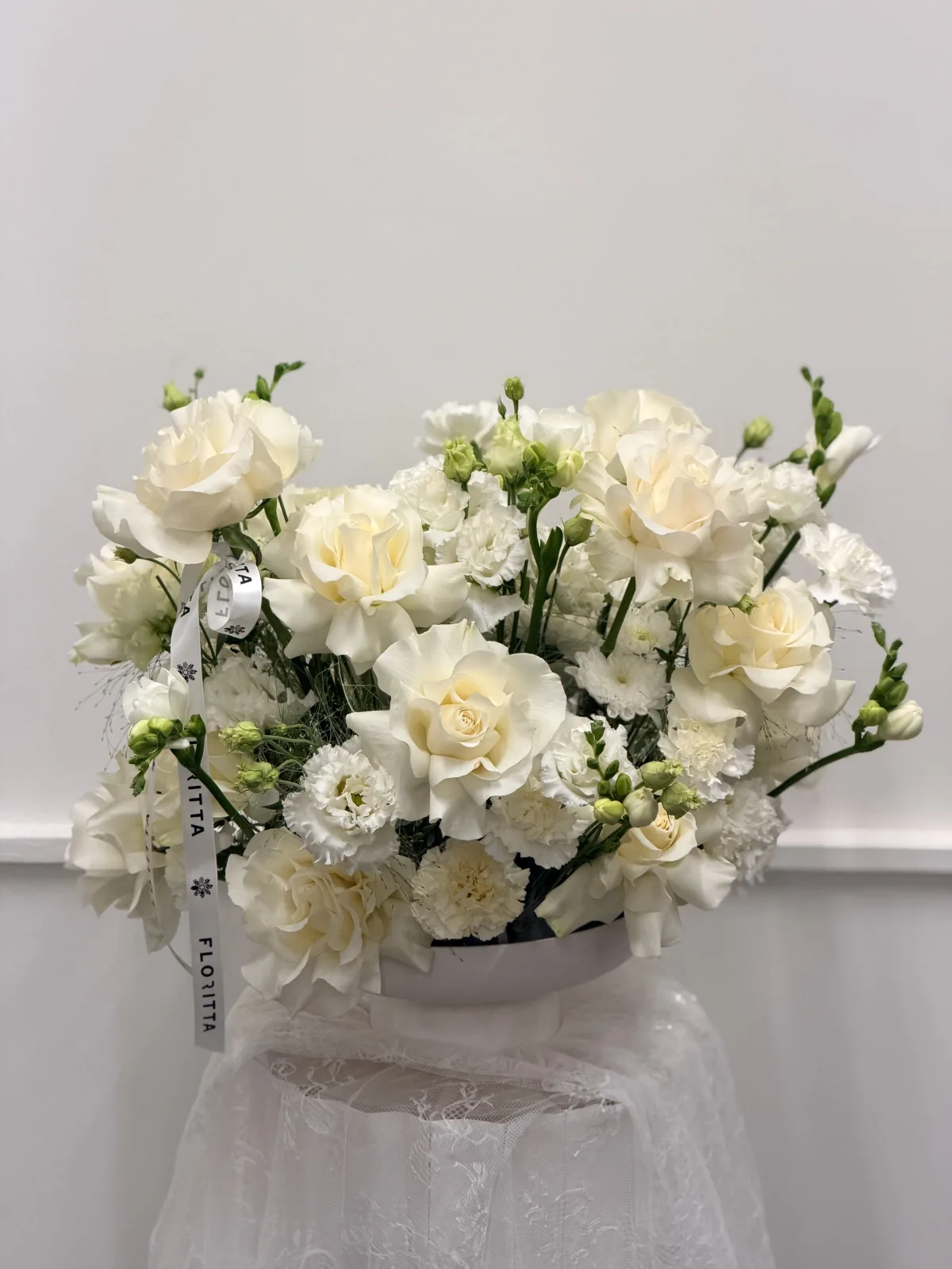 Pure white bowl arrangement (roses, carnations, freesia)